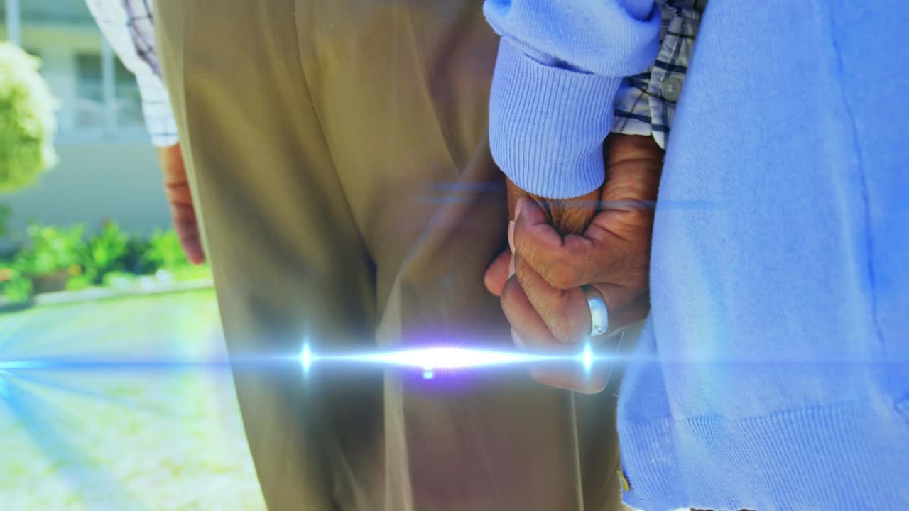 손을 잡고  ⁇ 는 고령 커플의 중간 부분을 가로질러 움직이는 빛의 애니메이션