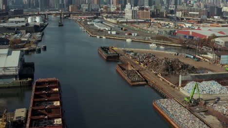 Vorwärts-Fliegen-über-Newtown-Creek-Und-Industrieanlagen-Entlang.-Kippen-Sie-Die-Wolkenkratzer-Von-Manhattan-Nach-Oben.-New-York-City,-Vereinigte-Staaten