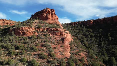 aerial view of doe mountain in sedona arizona as drone ascends in late afternoon