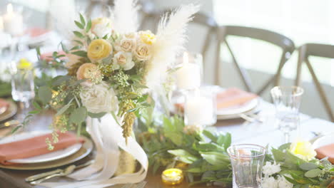 dining wedding table beautifully prepared with flower bouquet and cutlery to accommodate guests