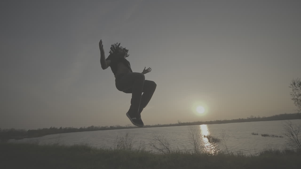 Acrobatic Street Dancer at Sunset by the River