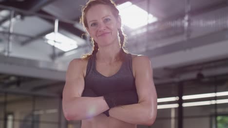 portrait of smiling mature woman wearing fitness clothing standing in gym ready to exercise 3