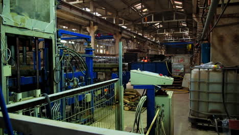 inside the building warehouse with metal and concrete beams. equipment in the plant for lifting and moving heavy weights.