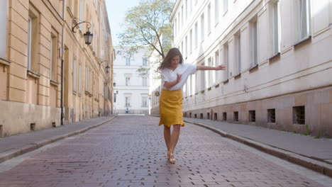 beautiful woman dancing latin dance alone in the old town street 5