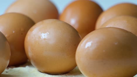 close-up of brown eggs rotating in the shot