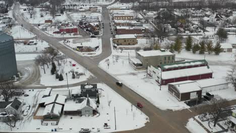 Small-American-style-winter-town-with-cars-driving-on-street-in-aerial