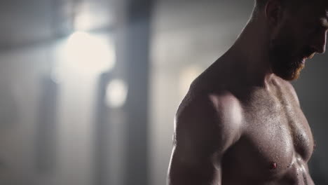 preparing for the exercise training. fitness man athlete chalk powder sportsman preparing training workout in gym ready for bodybuilding strength exercise slow motion.