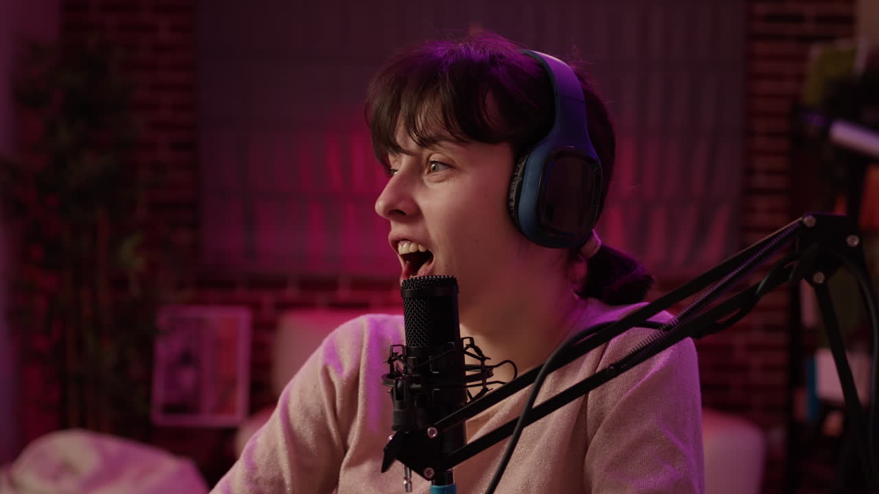 Portrait of online radio host recording interview with african american singer in late night entertainment