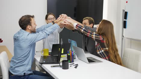 team at office celebrating successful work, slow motion