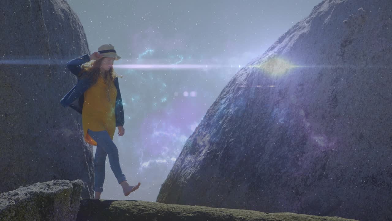 Woman stepping along ledge after gazing ahead, technology adding star field lens flare