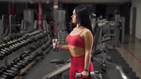 girl with dumbbells exercises over biceps