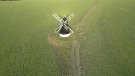 rising aerial view of pitstone windmill landmark on picturesque buckinghamshire rural countryside