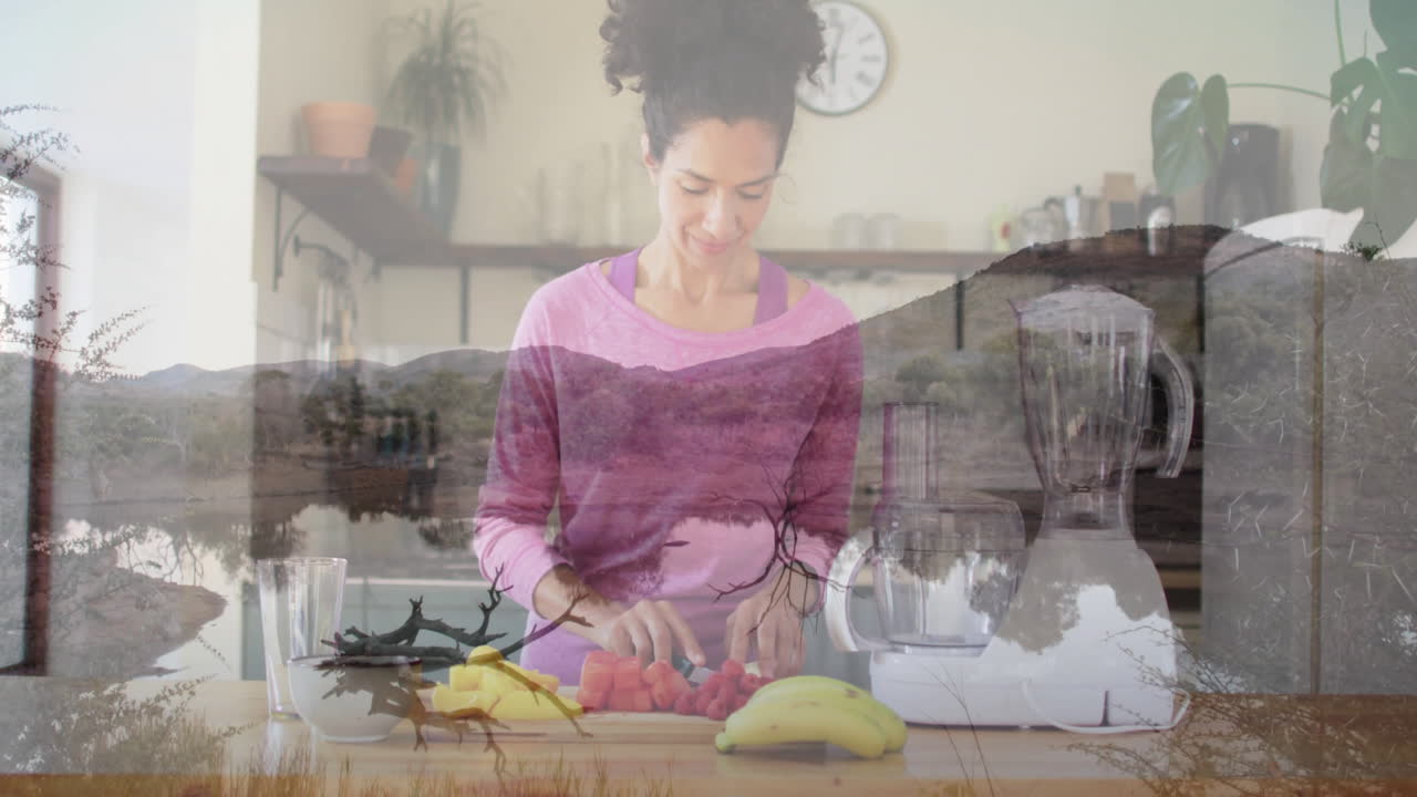 Preparing fruit in kitchen, woman with animation of serene mountain landscape