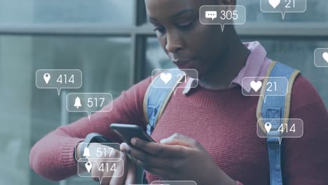 animation of social media icons with numbers over african american woman using smartphone