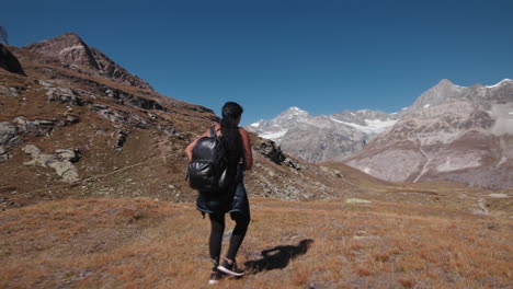 wide shot of hiker in alps mountains in switzerland