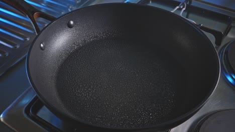 hot skillet sprayed with cooking oil in the kitchen