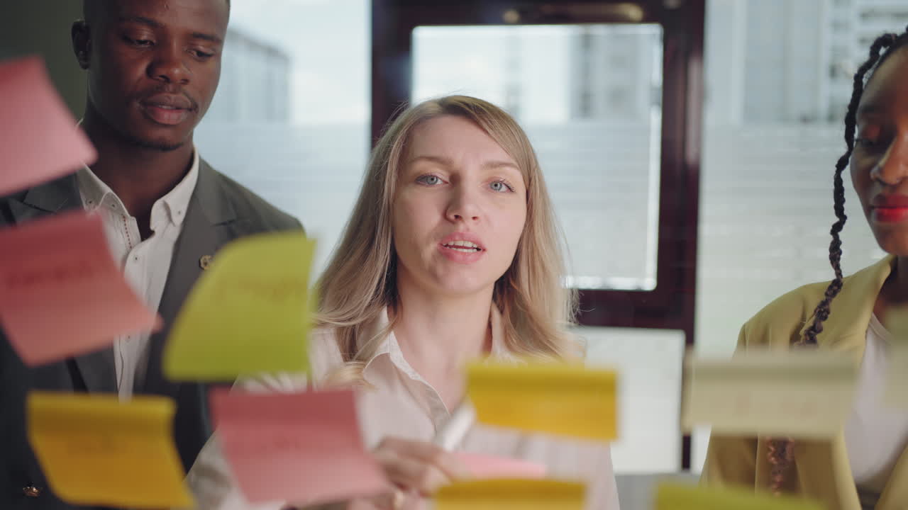 boss and employees are discussing new project and business development in office post-it notes