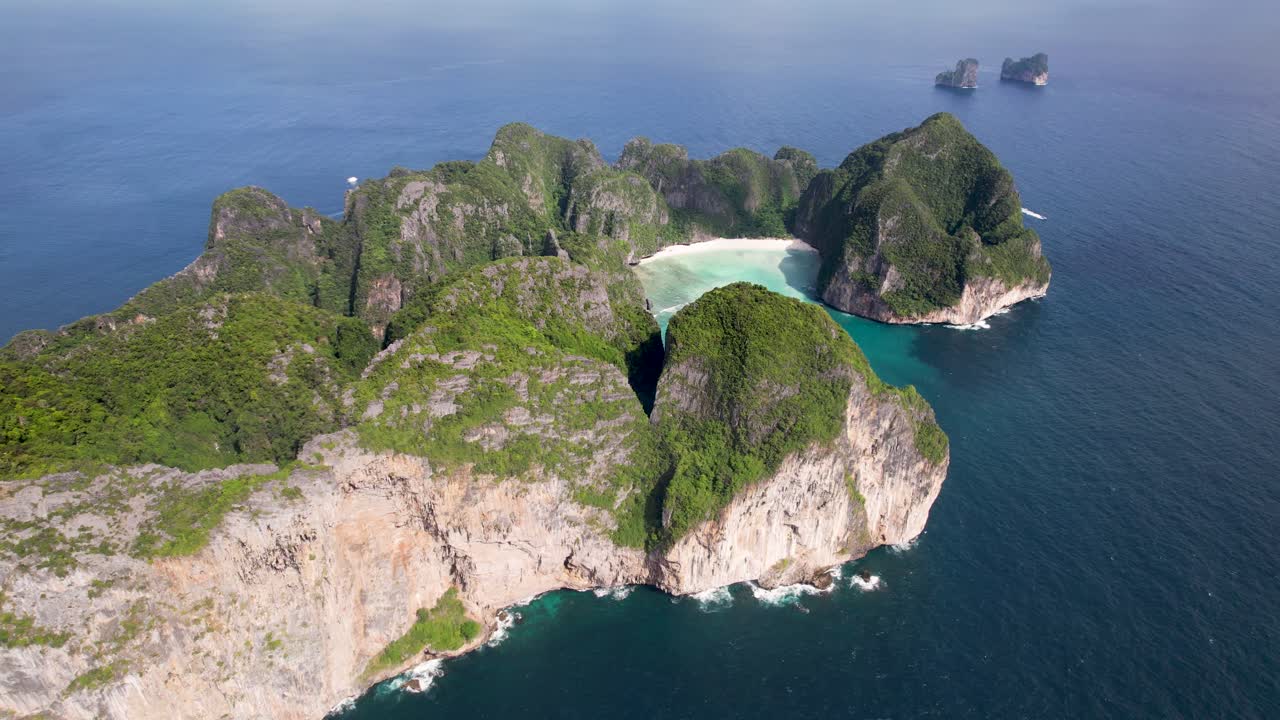 Aerial drone video of Phi Phi Leh with Maya Bay and Pileh Lagoon, Krabi province, Thailand. Aerial top view of amazing tropical island with turquoise water and white beach, famous travel destination.