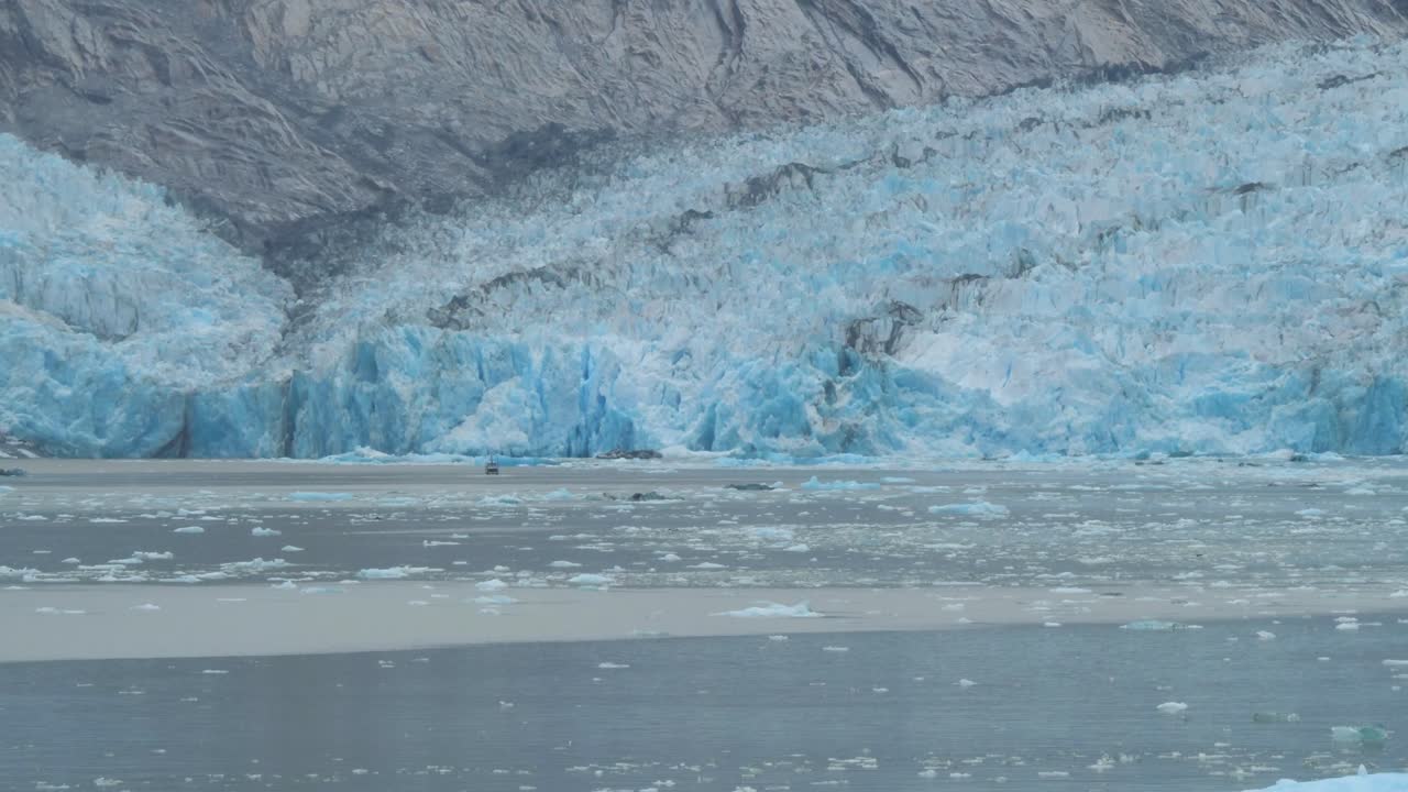 Dawes Glacier, Endicott Arm Fjord, Alaska. A small boat getting close to the glacier.