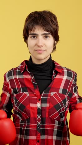 young person posing with red boxing gloves