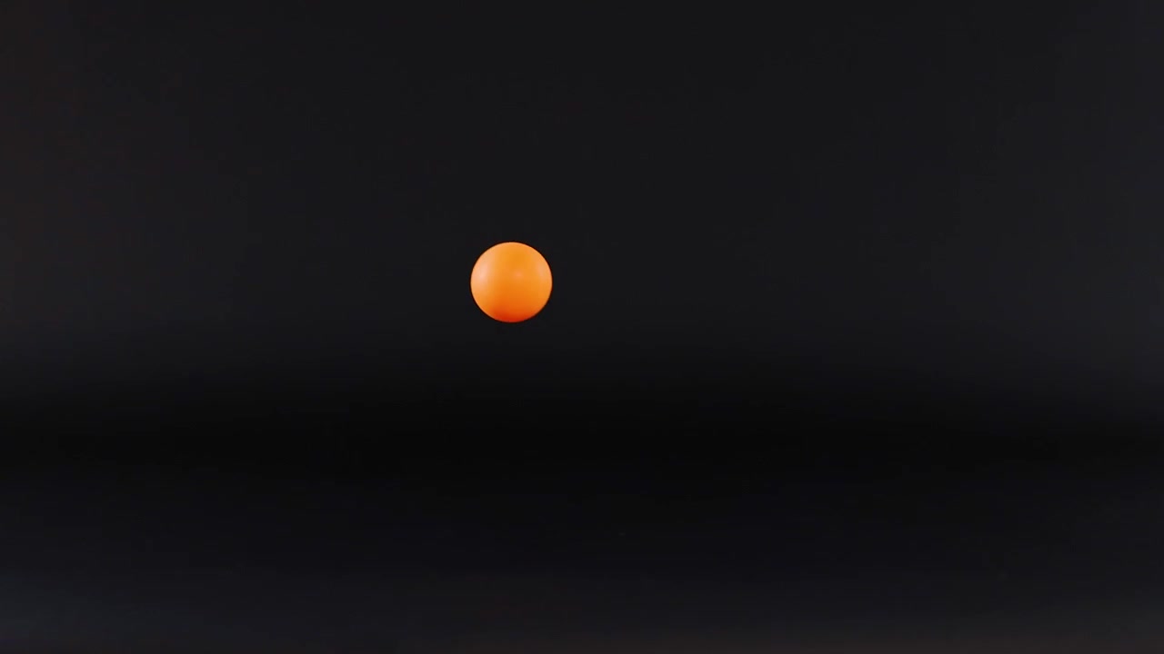Orange ball bouncing against a dark background