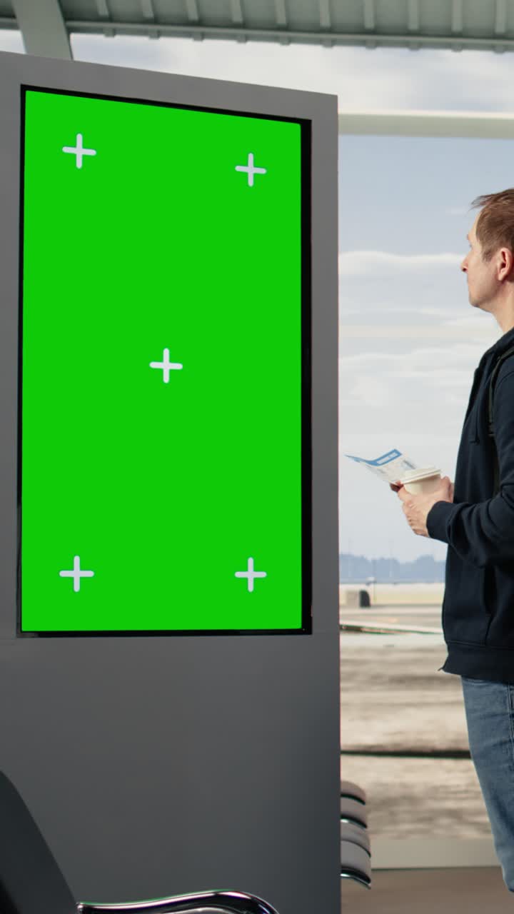 Vertical Video Chroma key board screen near traveler standing in airport terminal