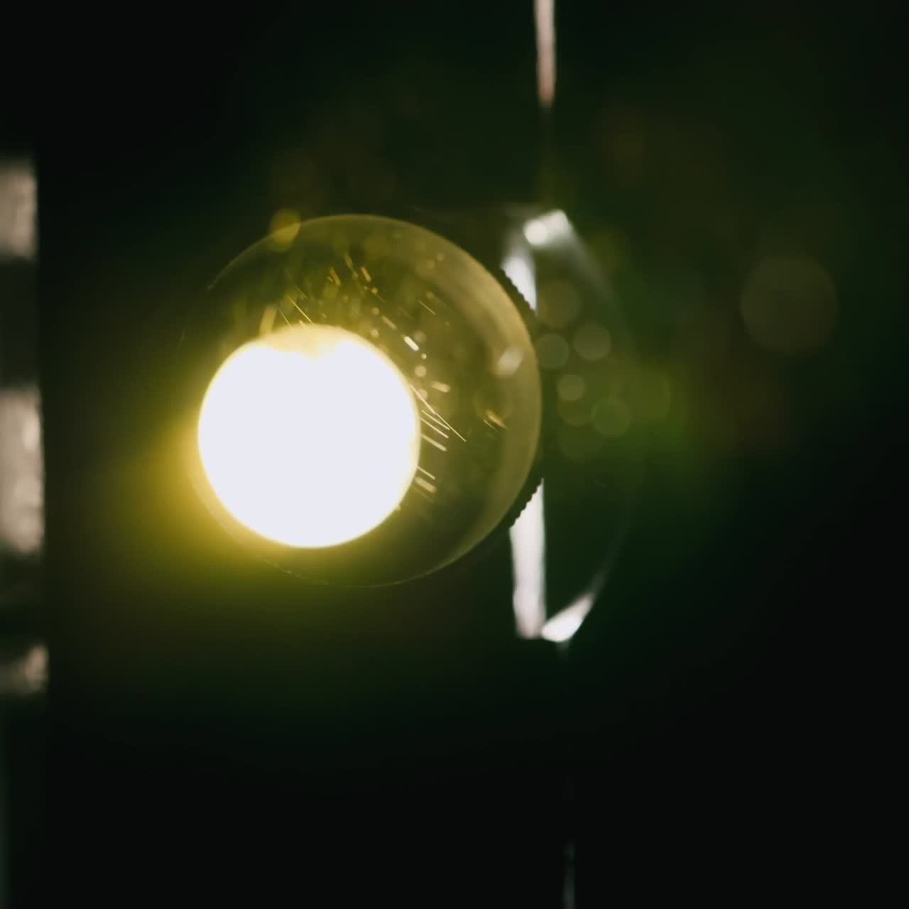 Close-up of vintage projector light flickering in the dark