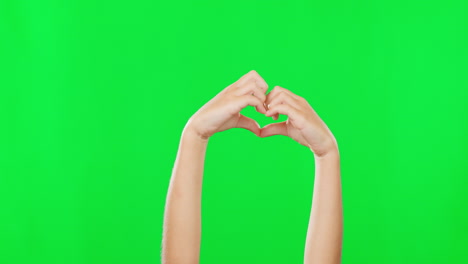 Person,-hands-and-heart-sign-on-green-screen