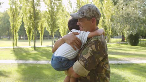 excited kid running to military dad's open arms