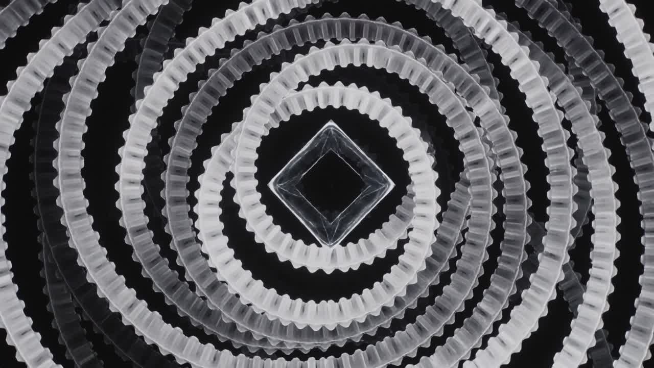 In riproduzione, anelli concentrici trasparenti smerlati ruotano, spostandosi per formare un'apertura a diamante creando un effetto moiré.
