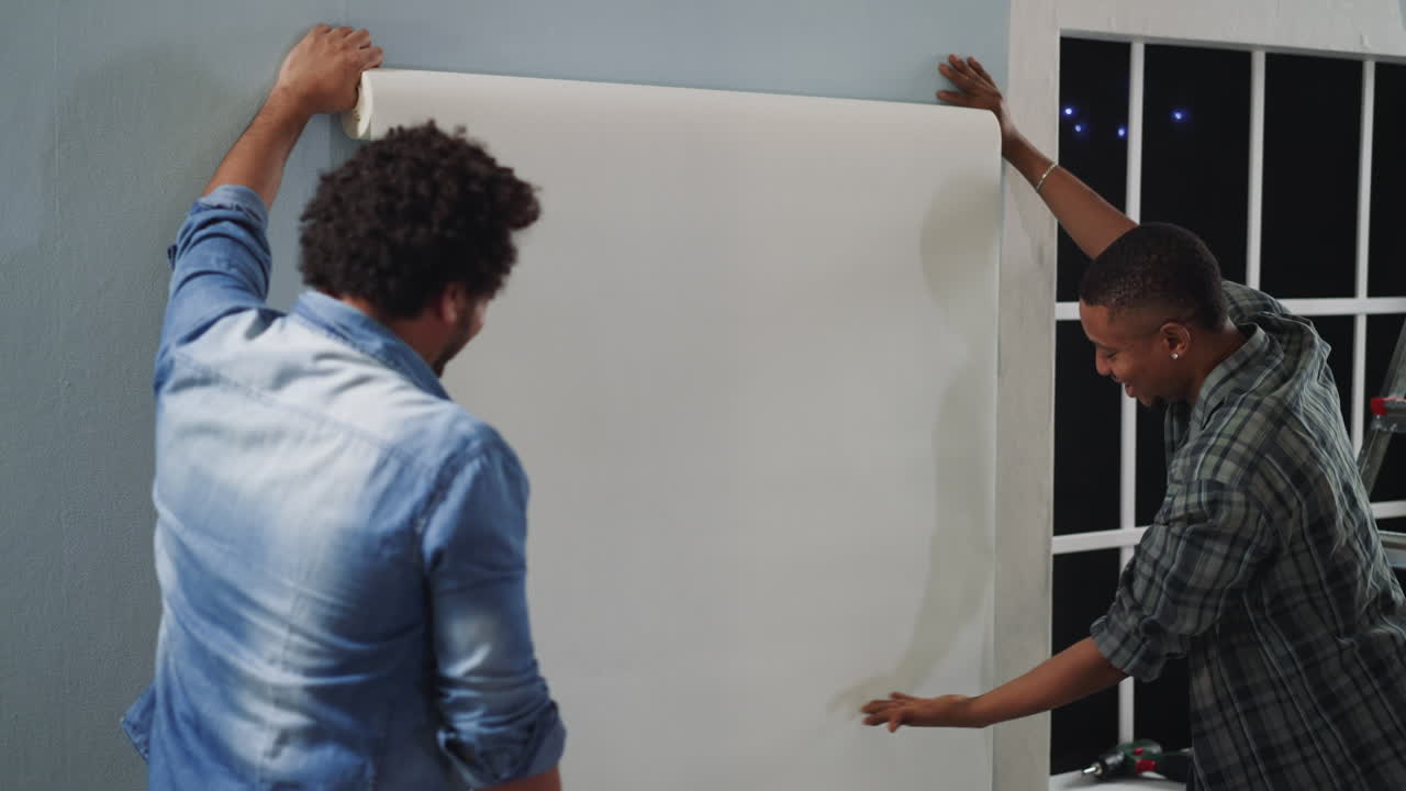 African-American designer talks to colleague in apartment