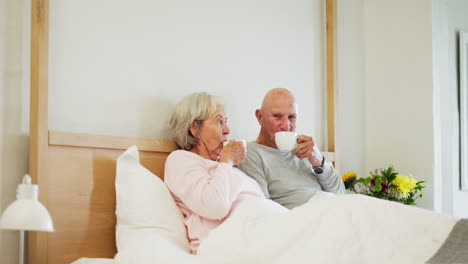 Coffee,-toast-and-senior-couple-in-a-bed