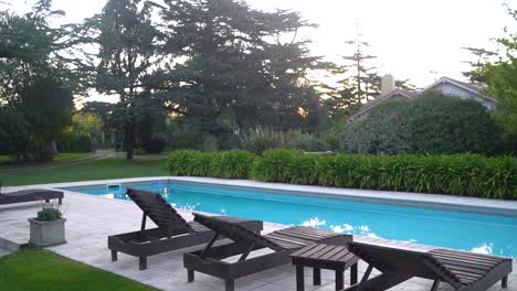 chaise lounge chairs on poolside at vacation villa