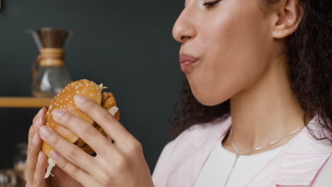 close-up of a person eating a burger