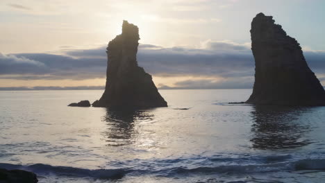 sunrise or sunset over majestic sea stacks and coastal landscape
