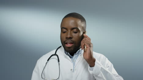 Angry-Nervous-Young-Man-Physician-Talking-And-Screaming-On-The-Phone-While-Disputing