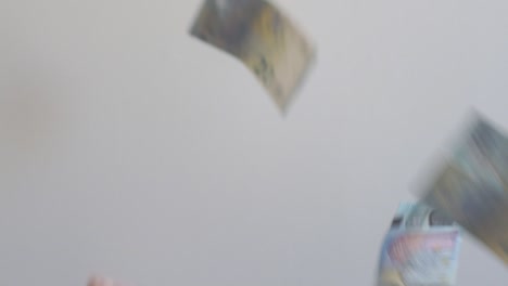 euro bills falling in slow motion on a white background