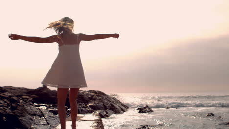 Smiling-woman-in-white-dress-turning-round