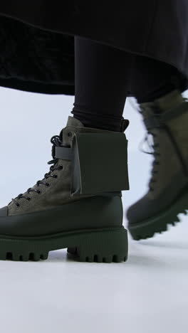 woman wearing trendy dark green boots