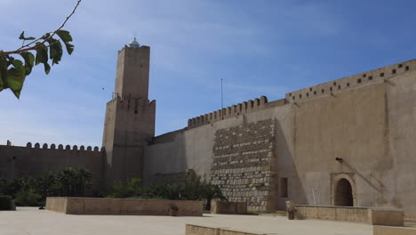 a majestic tunisian castle under clear skies, showcasing ancient arabic architecture