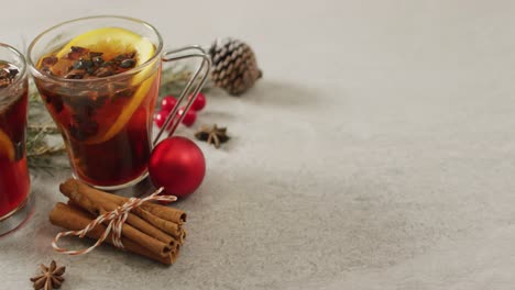 video of cups of hot tea with cinnamon and lemon over white background