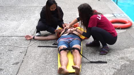 Kid-getting-strapped-up-in-spinal-board