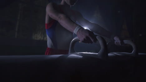 close - up of pommel horse on a dark background and smoke in slow motion male hands magnesia. preparation for the performance. olympic games