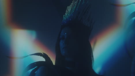 charming woman in gothic crown and feather costume