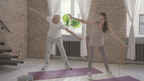 old male and female doing exercises at home