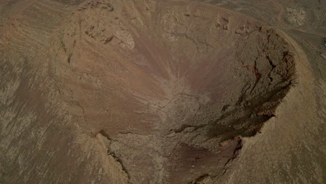 volcano crater. aerial view dolly out of volcano. interior of a volcanic crater and lava outlet area. canary islands. spain.