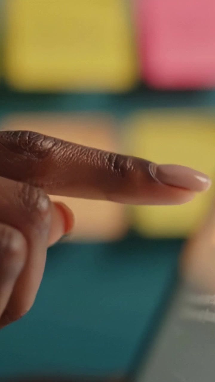 Fingers Interacting with a Tablet Screen Amidst Vibrant Sticky Notes, Capturing a Moment of Digital Engagement and Collaboration in a Learning or Creative Environment