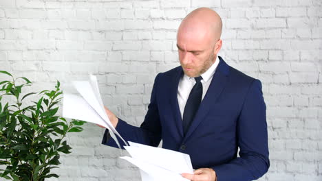 a business man looking through some papers at work