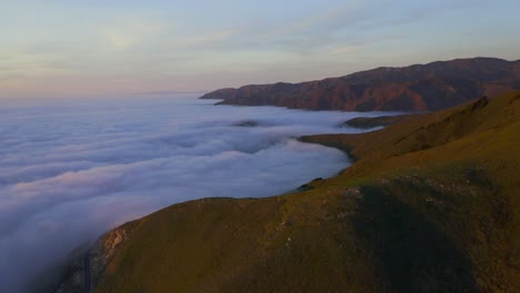 drone shots of pacific coast cliffs near big sur and carmel highlands california during marine fog layer and sunset