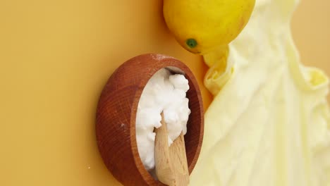 natural cleaning ingredients: baking soda, lemon, and wooden tools
